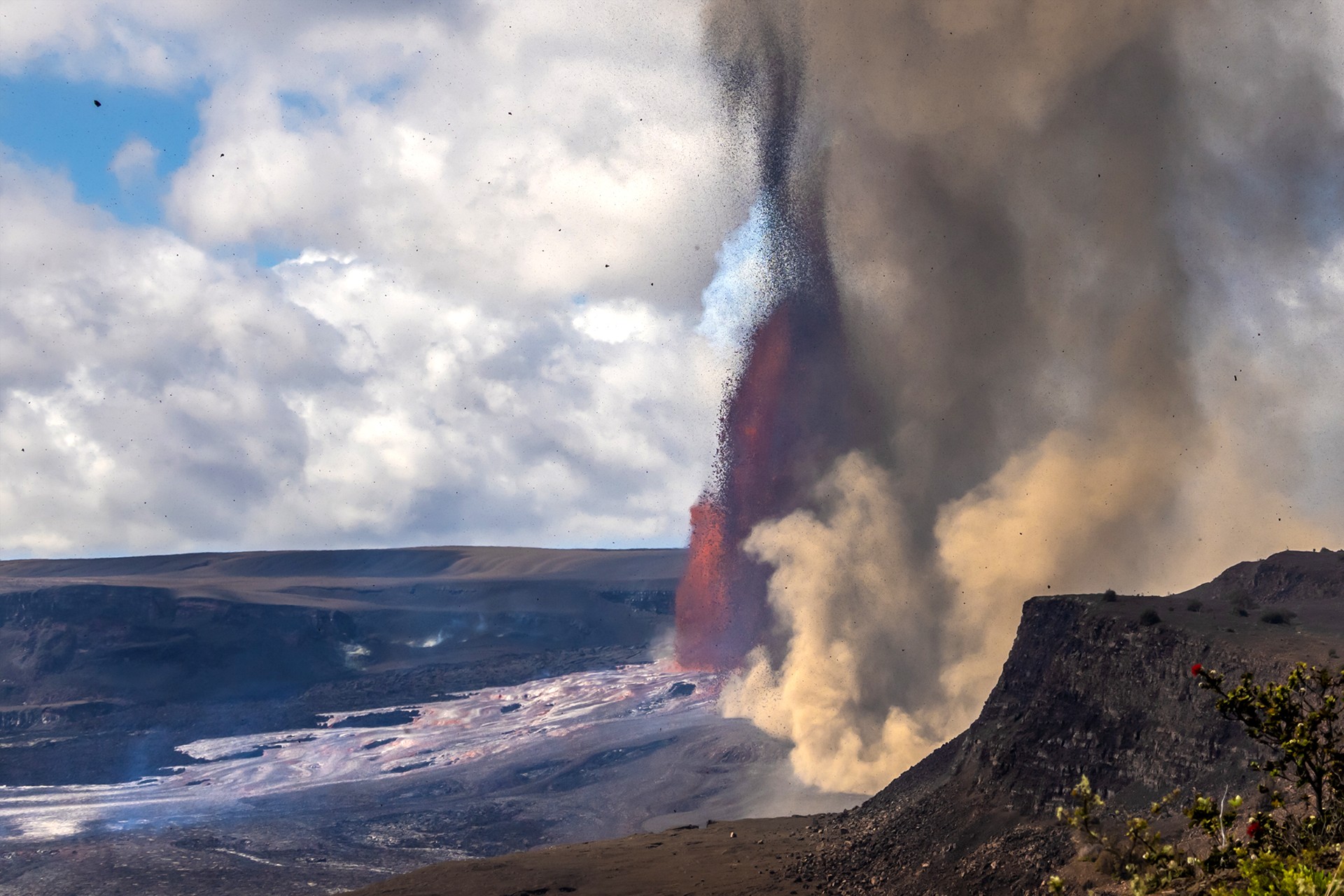 Fountain of molten lava erupting within a volcanic crater.
