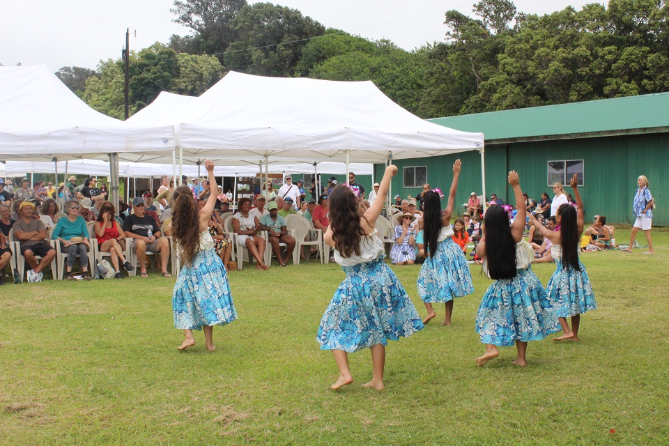 960-HAVO_20230722_Keiki perform hula at Kahuku Cultural Festival_J.Ferracane Young hula dancers perform for an audience seated outdoors under tents