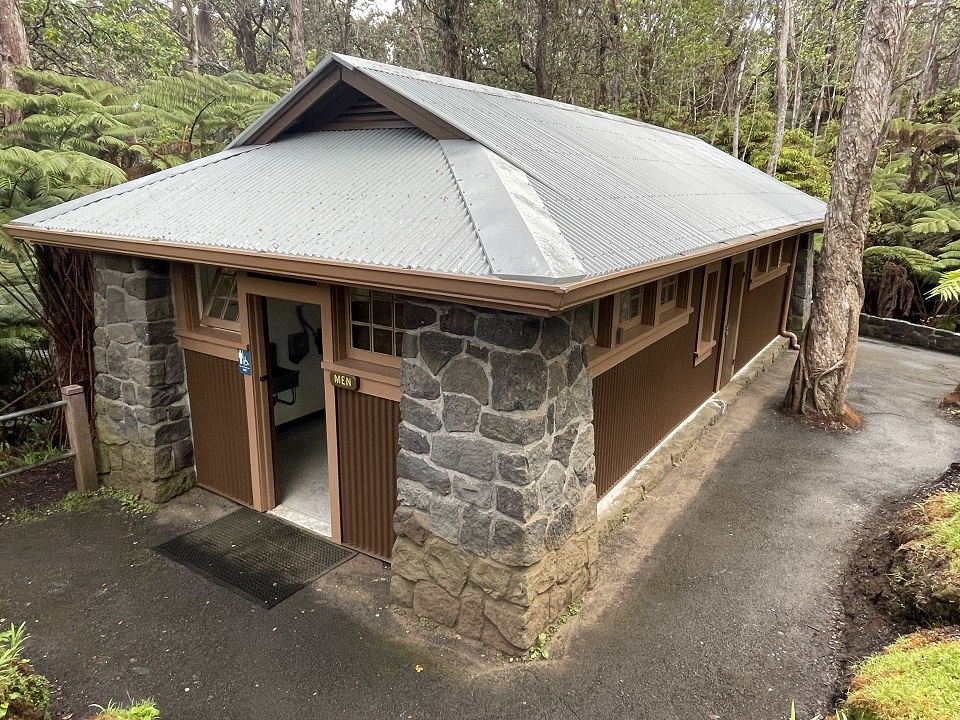 960-HAVO_20250331_Rehabed Nahuku restroom_J.Ferracane A single story stone and wood restroom in a forest