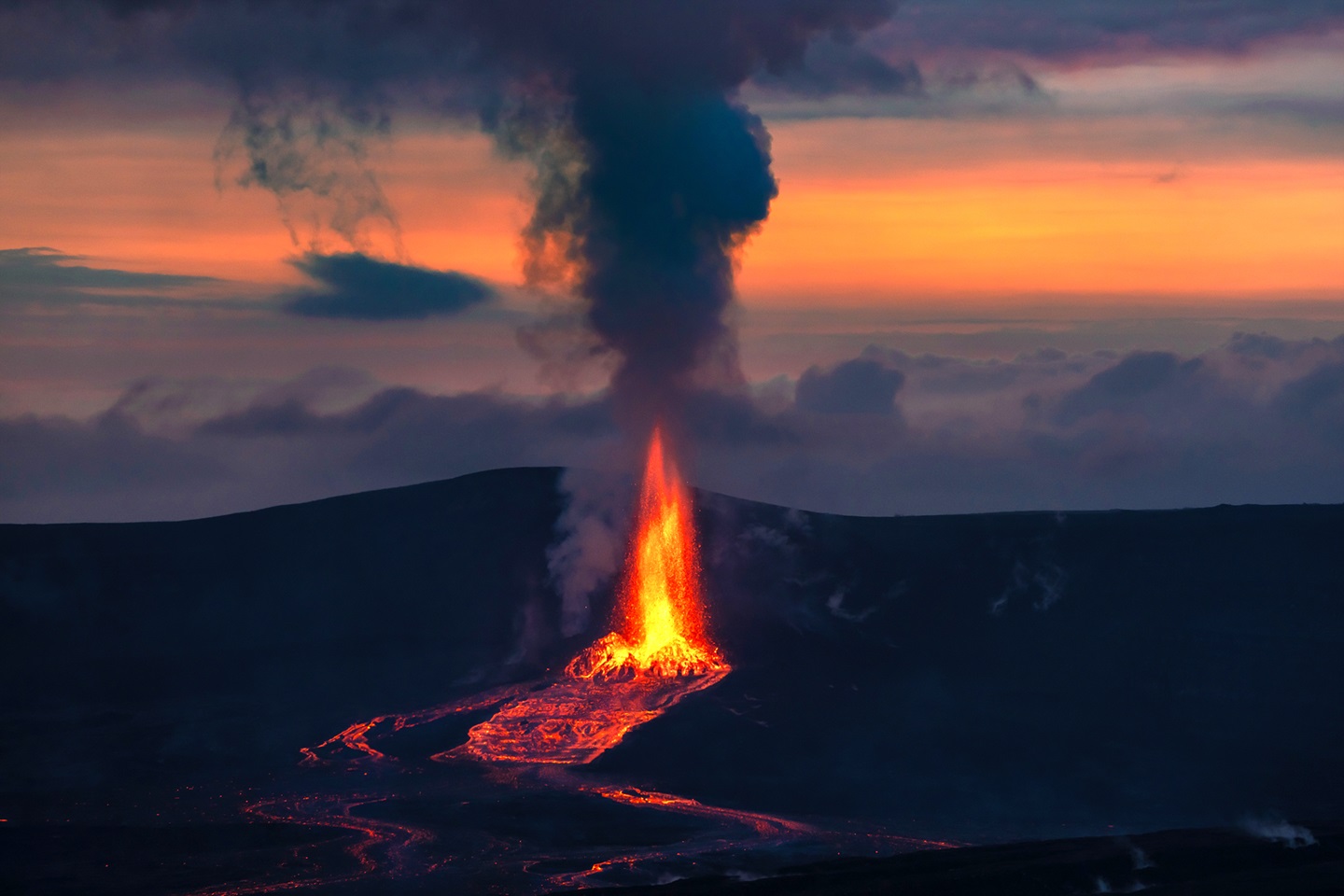 Lava erupts vertically from a volcano