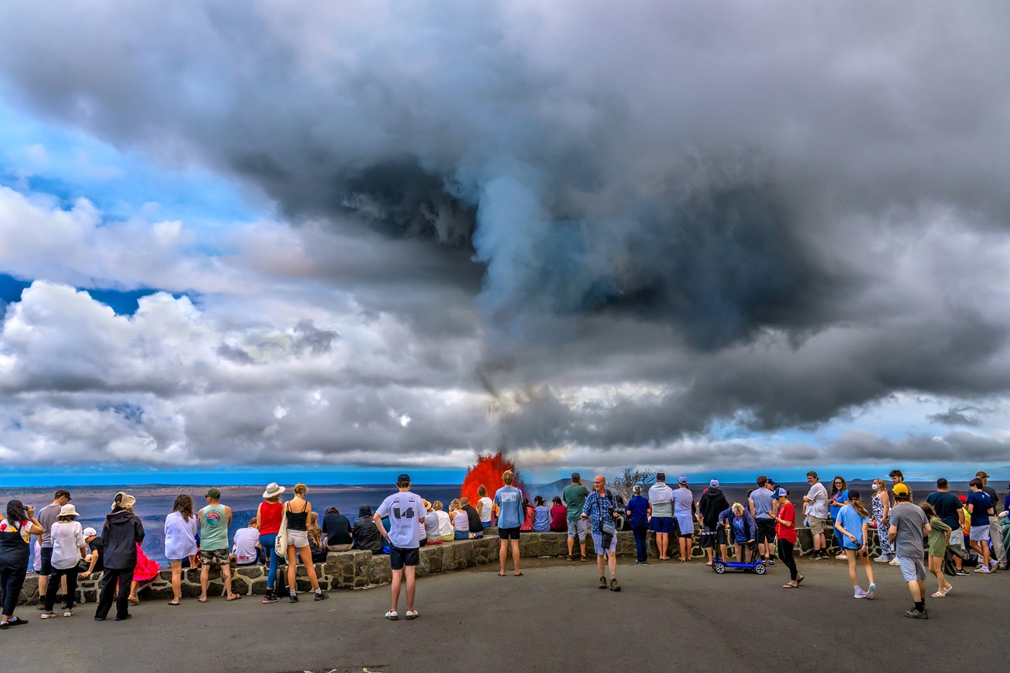 Visitors at an overlook watch Kilauea erupt