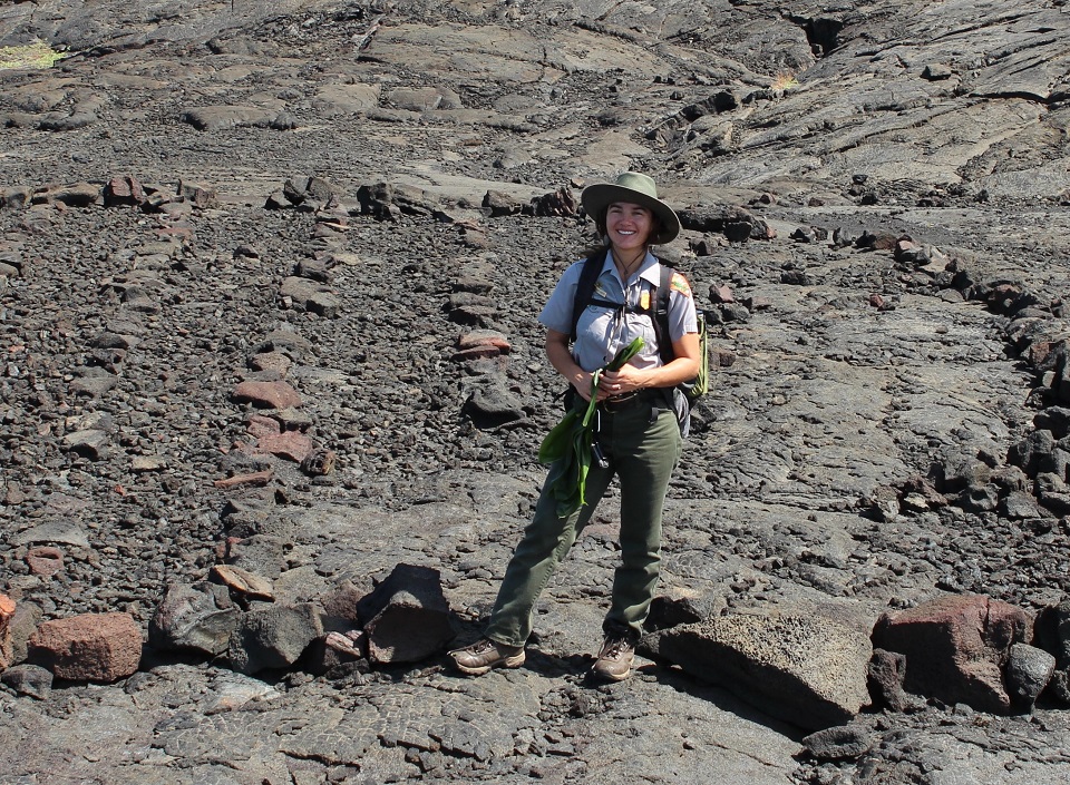 960-SummerCropped2 A park ranger stands in a dried lava field with rocks set in rows