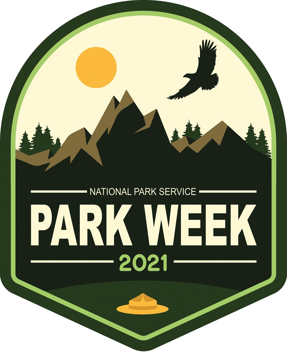 960-_National Park Week 2021 Logo (1) A lovely logo of green, yellow and brown showing a silhouette of a bird in flight over mountains and trees with a sun, and the words National Park Week 2021.