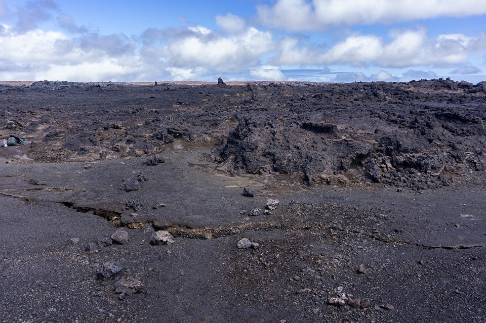 960-crack across the trail looking east A barren looking lava rock landscape fraught with earth cracks