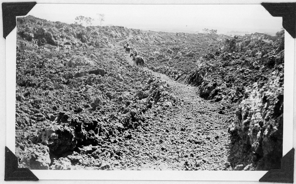 960- from 1931 November Supt report Old black and white photo of a rocky rough trail with two people on horseback in the distance