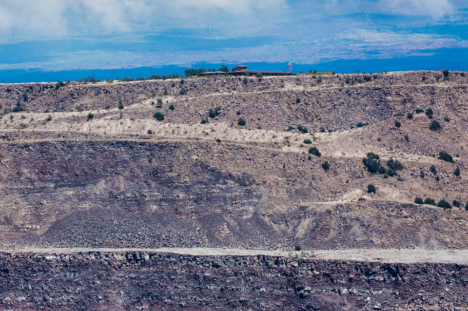 A building perched at the edge of a collapsed volcanic crater