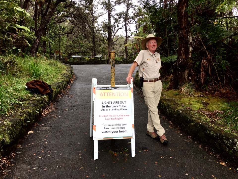 Volunteer John on duty at Thurston Lava Tube Volunteer stands near sign at Thurston Lava Tube