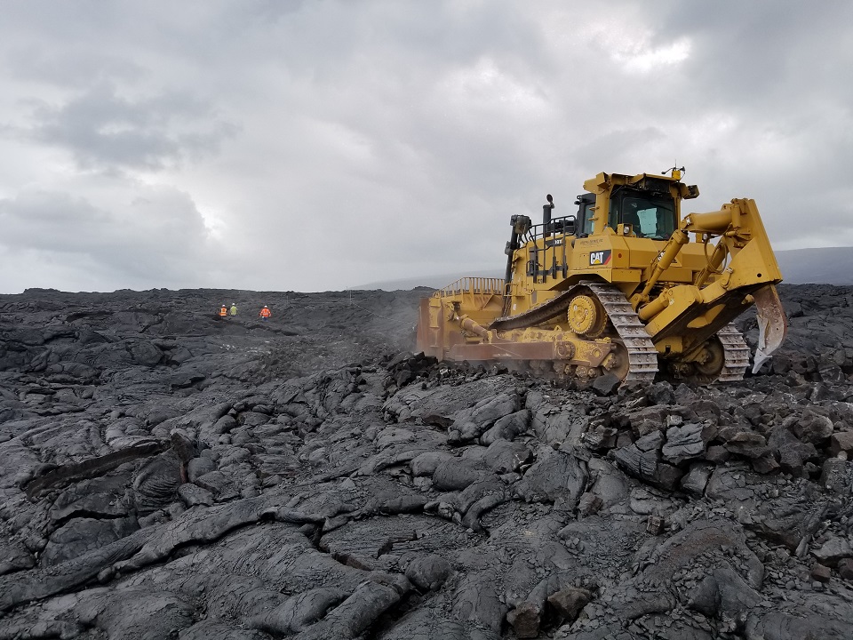 Work begins on Chain of Craters Kalapana Road. A bulldozer removes hardened lava