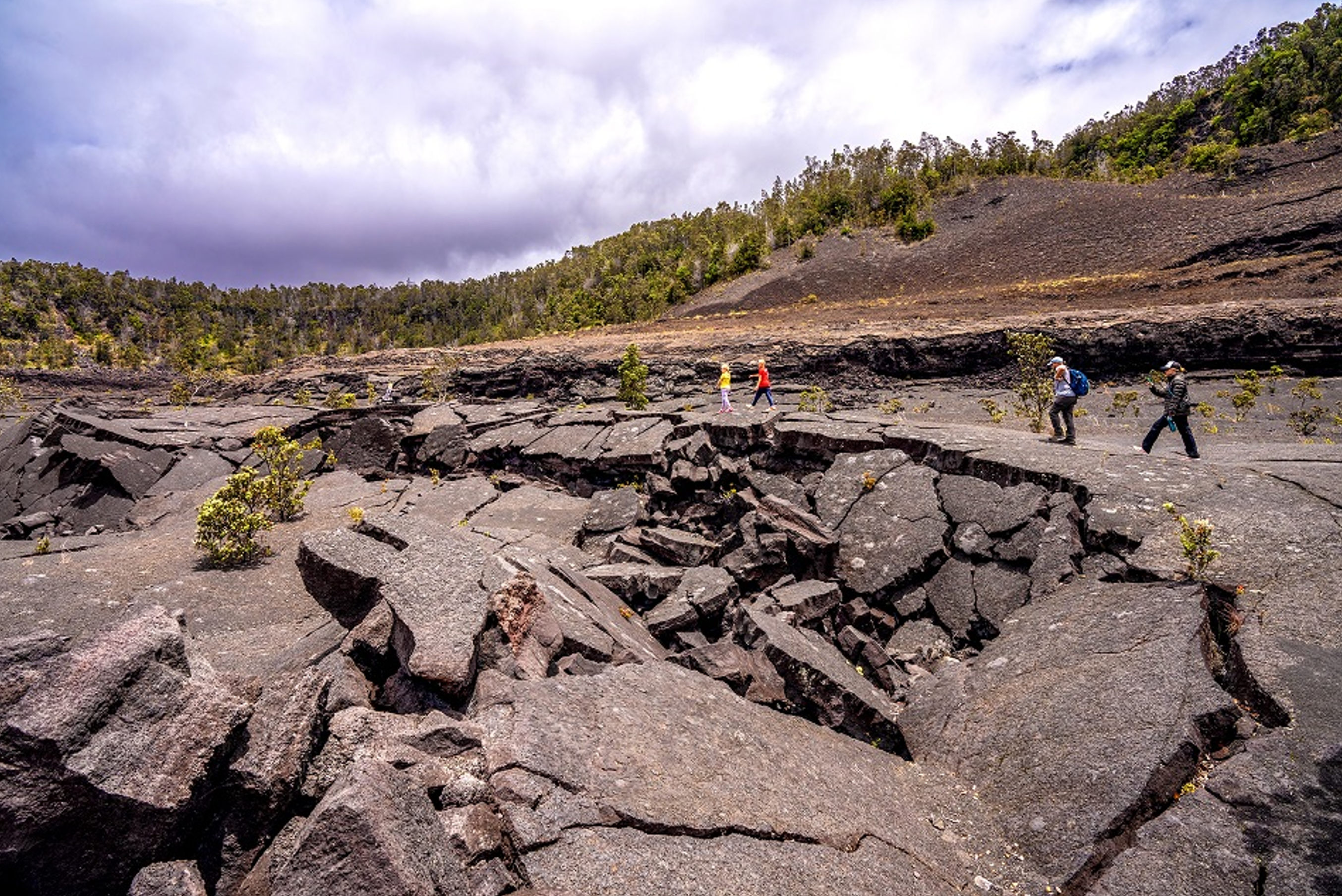 Group of people walking in a volcanic crater.