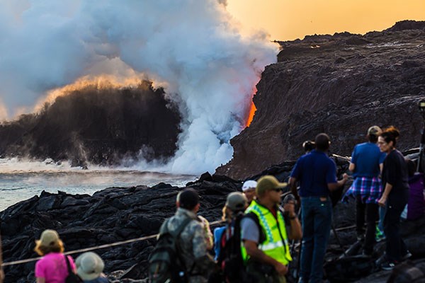 A Hawai‘i Volcanoes National Park eruption crew ranger ensures visitor safety at the Kamokuna lava viewing area on Feb. 24, 2017