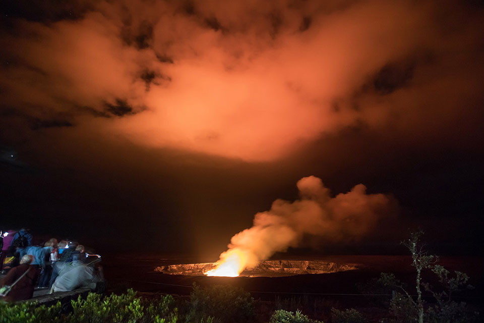 Visitors at Jaggar Museum overlook on Sunday evening enjoy the glow emanating from the lava lake deep within Halema‘uma‘u Crater