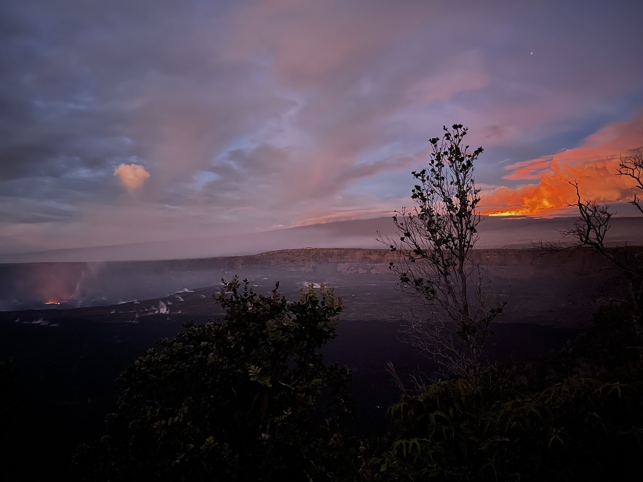 Two volcanoes erupt and glow at the same time