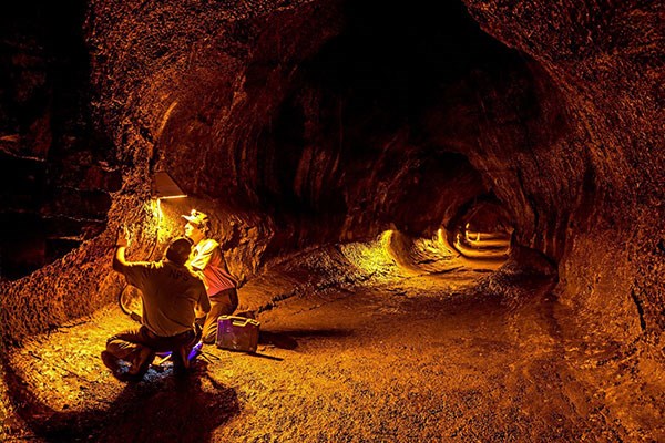 Hawai‘i Volcanoes National Park facilities maintenance crew, Alvin Asato (left) and Nick Satkofski, install new energy-efficient amber lighting to Nāhuku