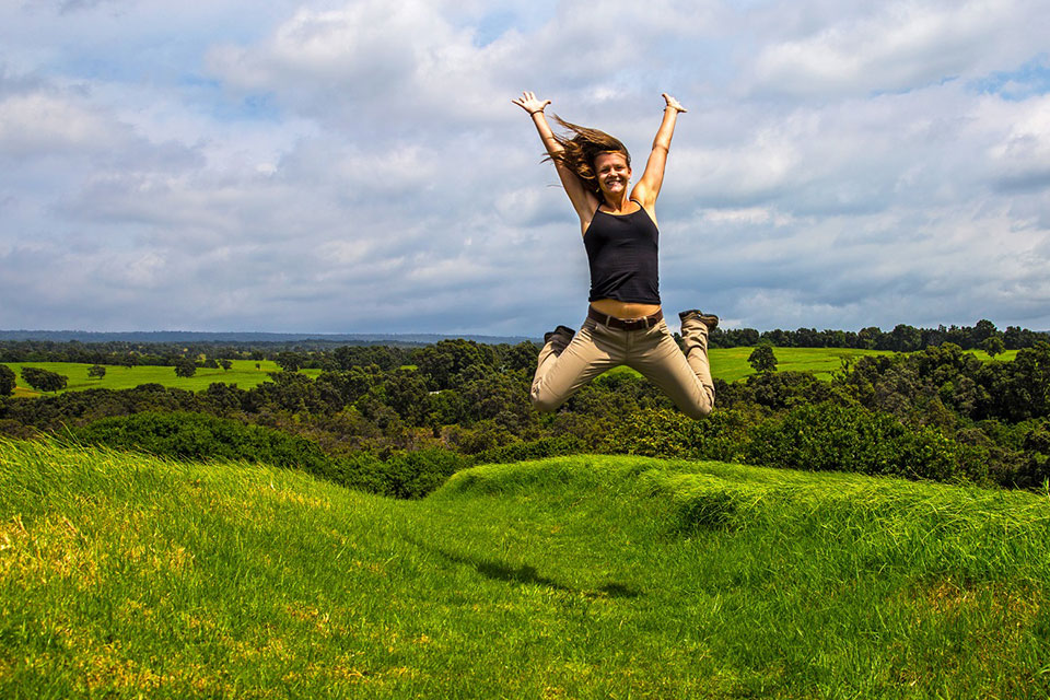 Photo of Kahuku visitor "jumping for joy" in Hawai`i Volcanoes National Park