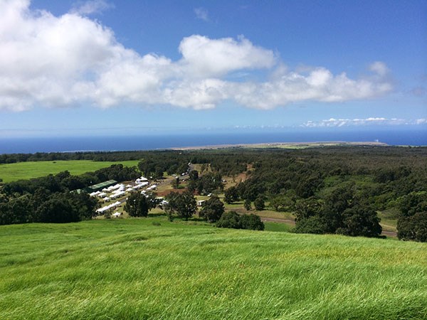 A sweeping view of Kahuku, looking down on the 2014 cultural festival, and the coast from the top of Pu‘u Lokuana cindercone