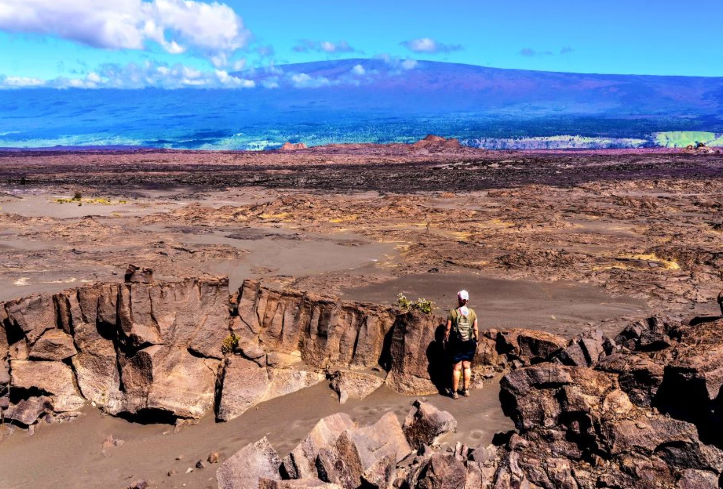 A lone hiker enjoys scenic views in the Kaʻū Desert