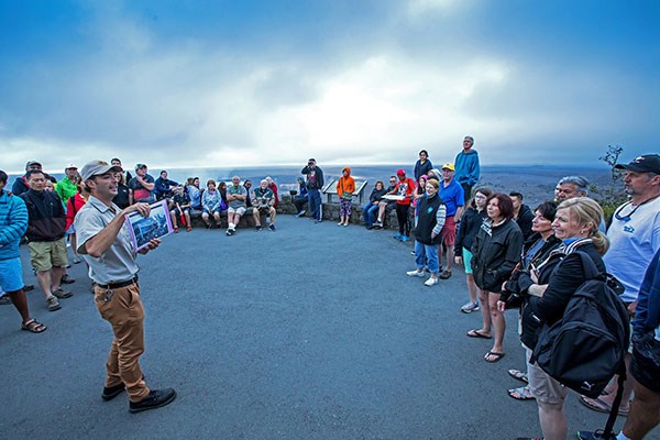 NPS Volunteer Marius Arigot gives a talk at Jaggar Museum Overlook to a crowd of visitors