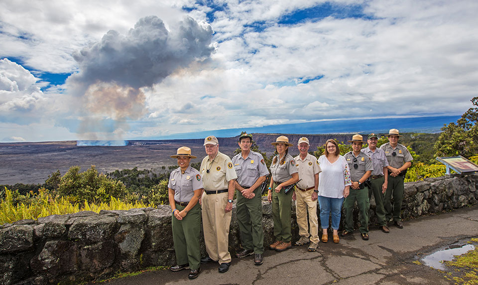 Some of the veteran staff and volunteers at Hawaii Volcanoes National Park stand on the northeast rim of Kīlauea caldera, behind Volcano House.