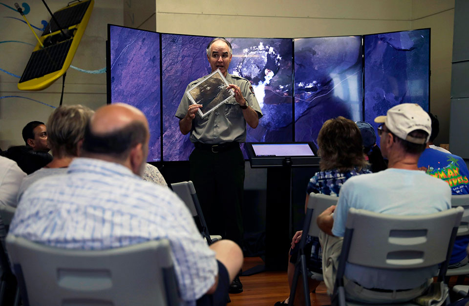 Ranger Dean shares eruption update to visitors at Mokupapapa Discovery Center in Hilo