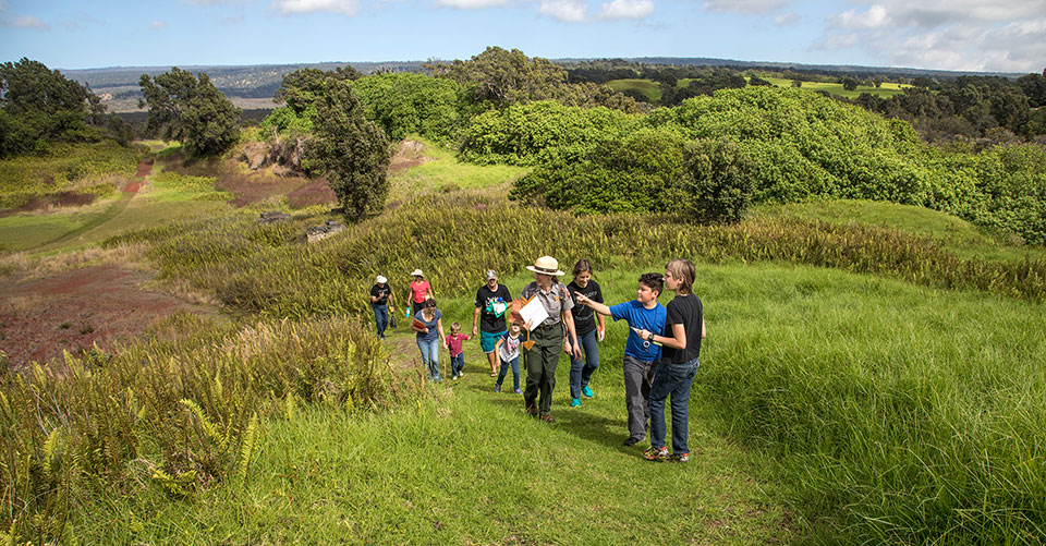 Park Ranger Jessica leads a family on a hike to the top of Pu‘u o Lokuana cindercone in the Kahuku Unit of Hawai‘i Volcanoes National Park. Park Ranger Jessica leads a family on a hike to the top of Pu‘u o Lokuana cindercone in the Kahuku Unit of Hawai‘i Volcanoes National Park.