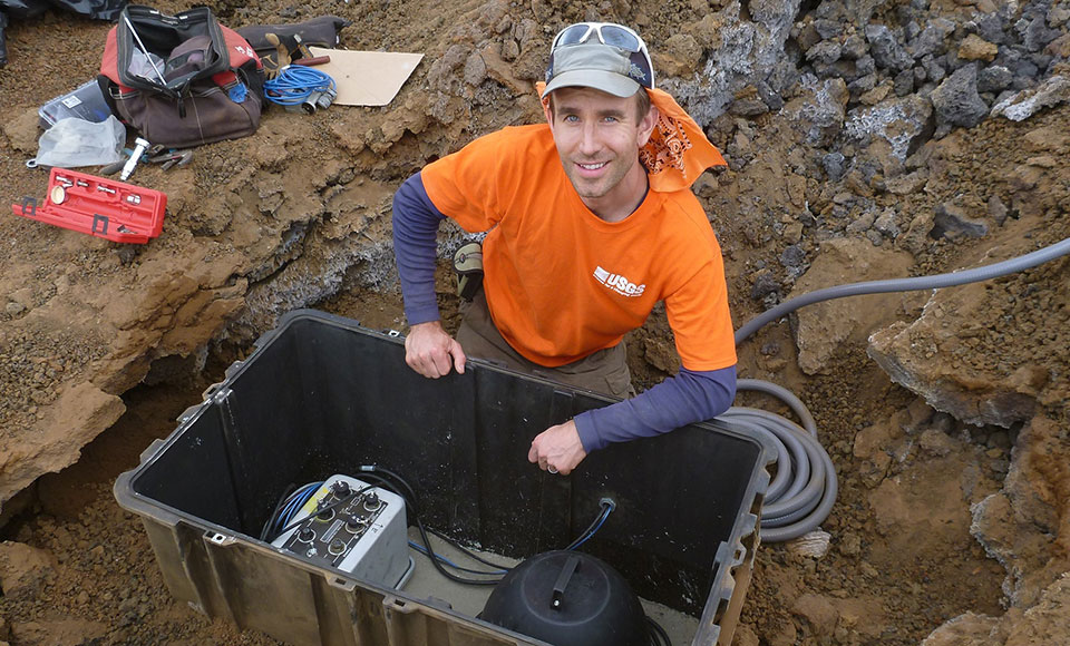 USGS Hawaiian Volcano Observatory's Seismic Network Manager Brian Shiro installs a broadband seismic monitoring station in the park's Kahuku Unit in June 2016