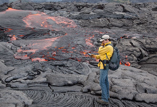 Hawaiian Volcano Observatory geologist mapping a lava flow in 2012