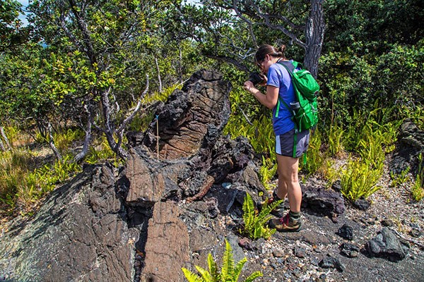 Visitor on Hi‘iaka and Pele hike at lava tree mold in Kahuku