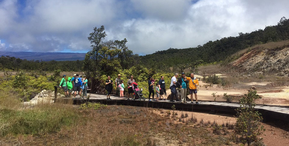 Visitors enjoy a ranger-guided hike at Sulphur Banks