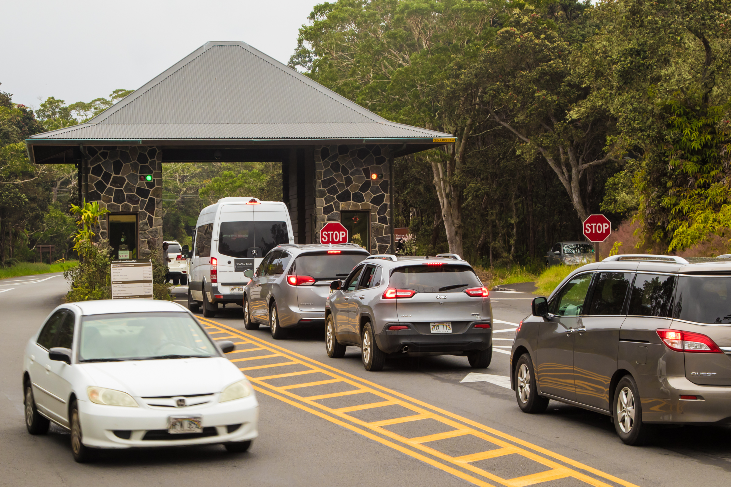 A line of vehicles on a road waits to enter Hawaii Volcanoes National Park