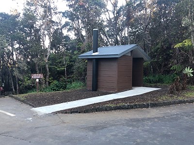 Vault toilet with accessible ramp