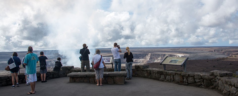 Visitors view the volcanic plume from Halema‘uma‘u Visitors view the volcanic plume from Halema‘uma‘u