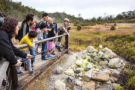 Ranger and visitors staying on boardwalk on Sulphur Bank Trail