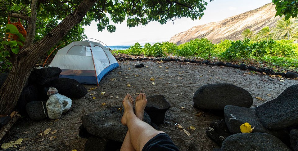 A camper enjoys the shade at Halapē