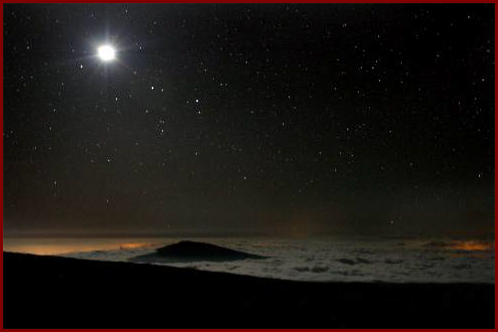 Lights of Kailua-Kona below a low cloud deck