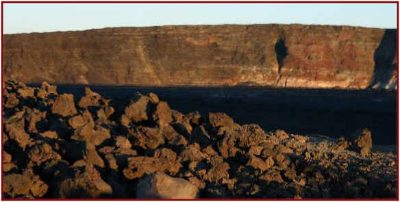 Basaltic rubble on the edge of the caldera at sunrise