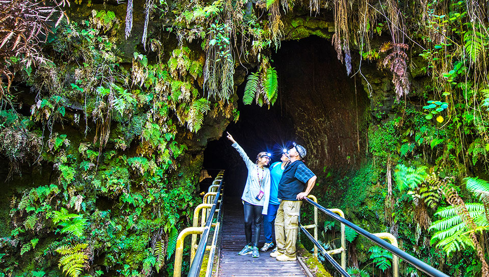 Family visiting lava tube equipped with headlights