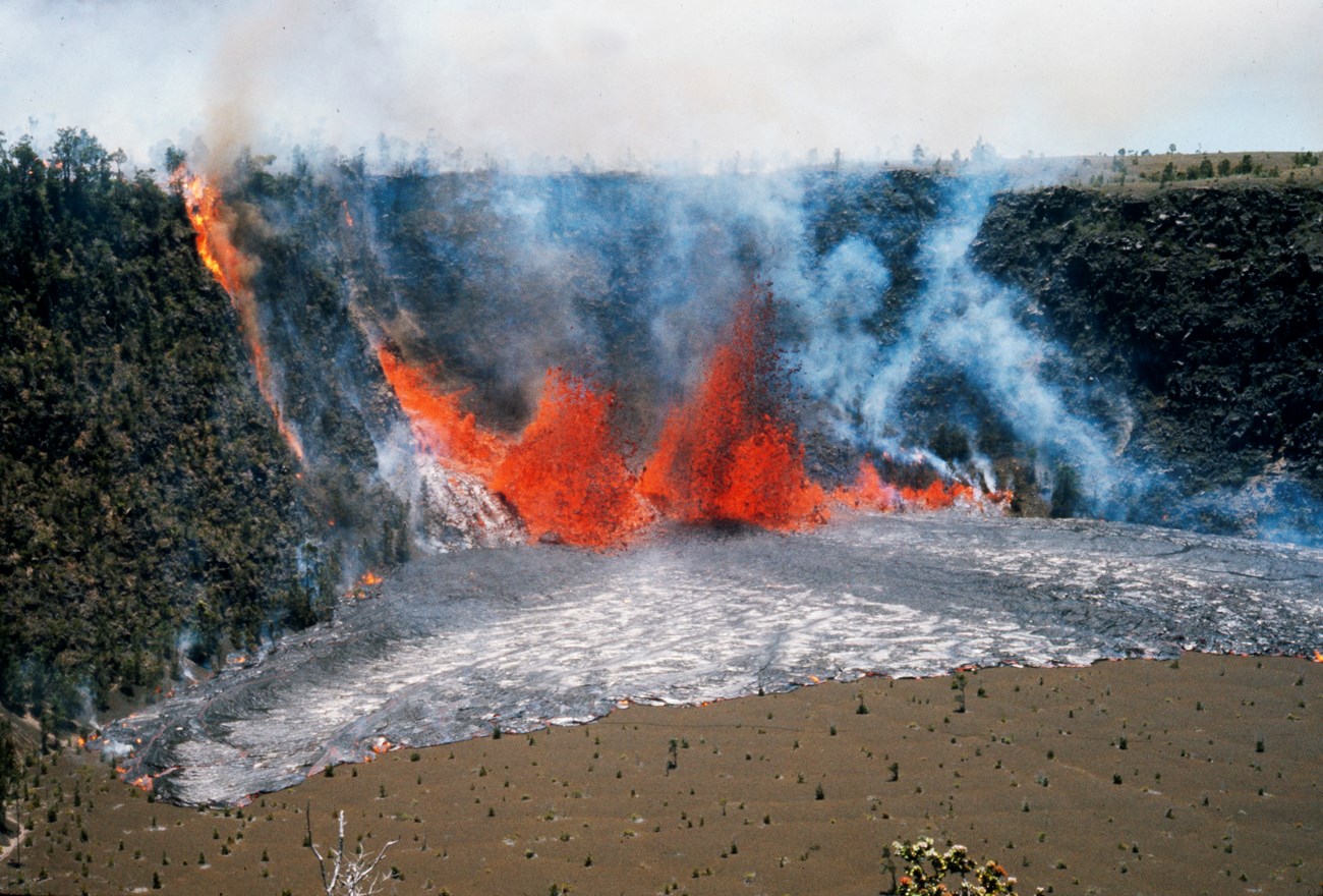 Lava fountaining from a fissure in the wall of a crater