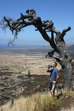 Drew drinks water under a tree. Drink plenty of water when hiking