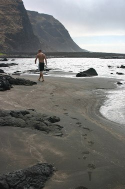Drew walking along the deserted beach at Kalue.
