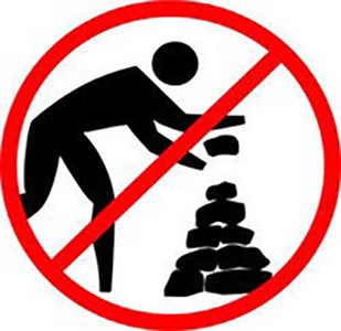 A graphic of a no symbol over a person stacking rocks