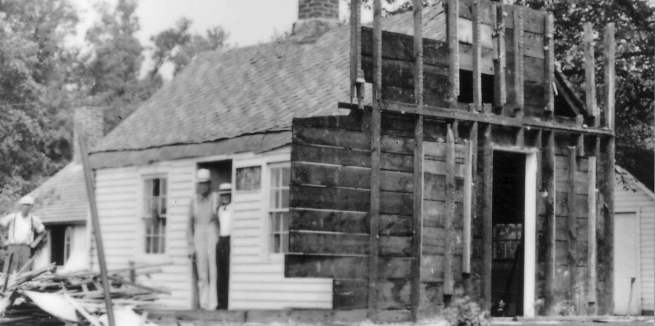 Birthplace Cottage Restoration, 1938 Workers pose by a small house under restoration in a 1930s photo.