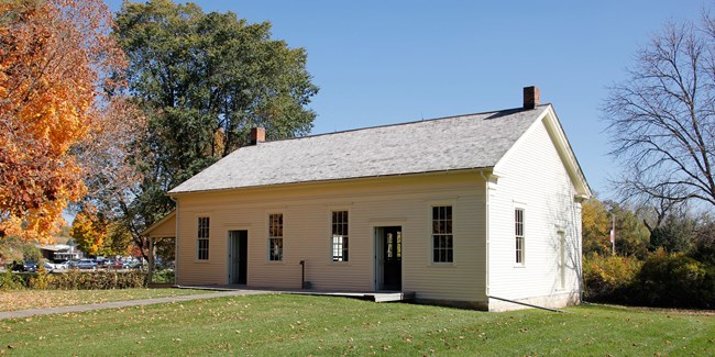 Friends Meetinghouse at Herbert Hoover NHS Two doorways, one on either side, of a broad white wood frame building divides the sexes.
