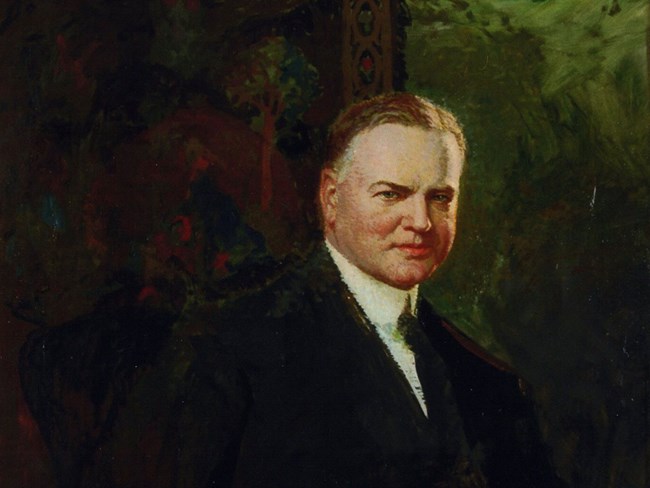 Herbert Hoover, President-Elect by Henry Salem Hubbell A portrait painting shows a middle aged man in a suit sitting in a dark room.
