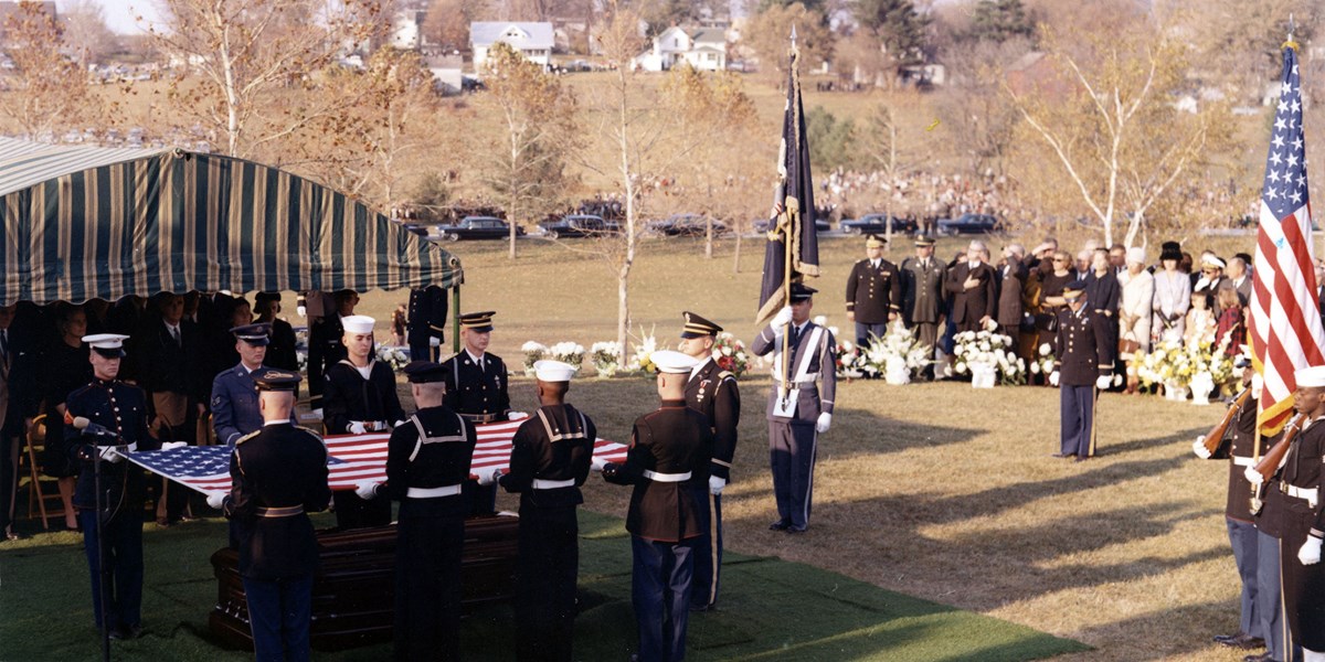 Herbert Hoover's burial, 1964 Mourners look on as American servicemen fold a flag over a coffin.
