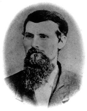 Oval-cropped black-and-white portrait photograph of a young dark-haired man with a long beard. Oval-cropped black-and-white portrait photograph of a young dark-haired man with a long beard.