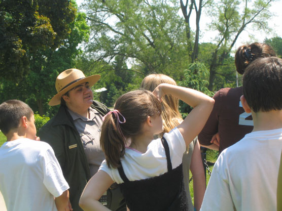 Park ranger leading an outdoor walking tour.