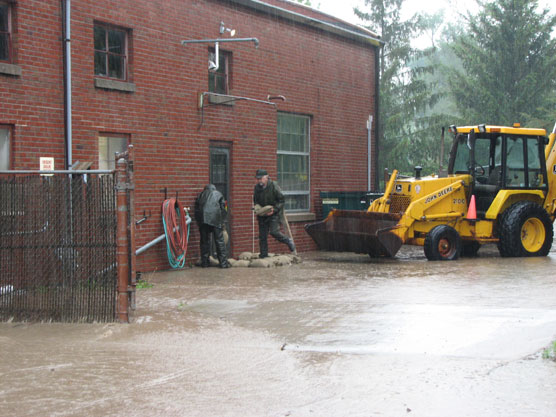 Park employees build a sandbag dike at the park maintenance facility.