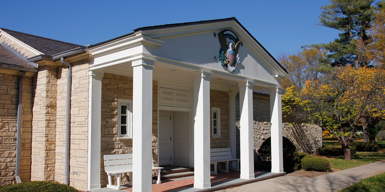 Herbert Hoover Presidential Library & Museum A white museum portico has a presidential seal mounted on the pediment.