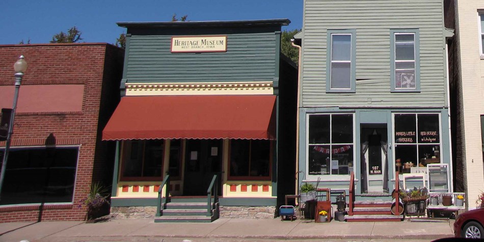 Restored wooden storefronts line a small town downtown street. Restored wooden storefronts line a small town downtown street.