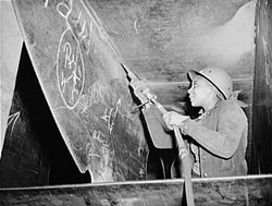 Miss Eastine Cowner, a former waitress, is helping in her job as a scaler to construct the Liberty ship SS George Washington Carver. Photo courtesy of Library of Congress